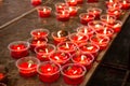 Burning red flower candle at chinese shrine for making merit in Royalty Free Stock Photo