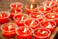 Burning red flower candle at chinese shrine for making merit in Royalty Free Stock Photo