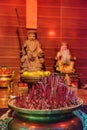 Burning red incense sticks in small Chinese temple Royalty Free Stock Photo