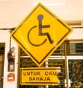 Burning of Reserved parking for Handicapped Only sign with Malaysian language `parking for handicapped only` beneath. Handicap sig Royalty Free Stock Photo