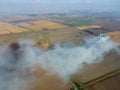 The burning of rice straw in the fields. Smoke from the burning of rice straw in checks. Fire on the field Royalty Free Stock Photo