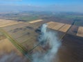The burning of rice straw in the fields. Smoke from the burning of rice straw in checks. Fire on the field Royalty Free Stock Photo