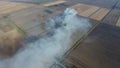 The burning of rice straw in the fields. Smoke from the burning of rice straw in checks. Fire on the field Royalty Free Stock Photo