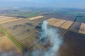 The burning of rice straw in the fields. Smoke from the burning of rice straw in checks. Fire on the Royalty Free Stock Photo