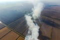 The burning of rice straw in the fields. Smoke from the burning of rice straw in checks. Fire on the Royalty Free Stock Photo