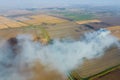 The burning of rice straw in the fields. Smoke from the burning of rice straw in checks. Fire on Royalty Free Stock Photo