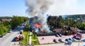 Burning roof of residential high-rise building, clouds of smoke from the fire. firefighters extinguish fire. top view Royalty Free Stock Photo