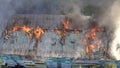 Burning roof of a residential high-rise building, clouds of smoke from the fire. top view Royalty Free Stock Photo