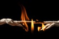 Burning rope at breaking point on black background, Risk concept Royalty Free Stock Photo