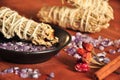 Burning sage and crystals on wooden background, pepper and cinnamon, amethyst