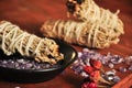 Burning sage and crystals on wooden background, pepper and cinnamon, amethyst