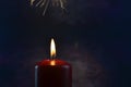 Burning single red candle with dancing flame on the dark background Royalty Free Stock Photo