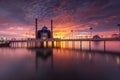 Burning sky at Losari Beach with 2 mosques on frame Royalty Free Stock Photo