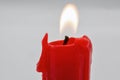 Burning red candle stub closeup on white Royalty Free Stock Photo