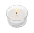 Burning small wax candle in glass holder isolated on white Royalty Free Stock Photo
