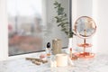 Burning soy candles, cosmetics and stylish accessories on white window sill indoors Royalty Free Stock Photo