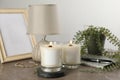 Burning soy candles with wooden wicks and decor on grey table Royalty Free Stock Photo