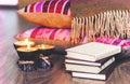 Burning spa aroma candles in coconut shell, plaid and books, cozy home interior background