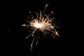 Burning sparkler isolated on black background. Fireworks theme. Light effect and texture