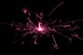 Sparkler in pink and white light on a black background Royalty Free Stock Photo