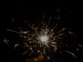 Burning sparkler producing spark around, celebration with fireworks and crackers during X mas and new year Royalty Free Stock Photo