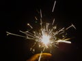 Burning sparkler producing spark around, celebration with fireworks and crackers during X mas and new year Royalty Free Stock Photo