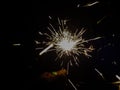 Burning sparkler producing spark around, celebration with fireworks and crackers during X mas and new year Royalty Free Stock Photo