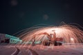 Burning steel wool on the excavator, winter night landscape,