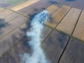 Burning straw in the fields after harvesting wheat Royalty Free Stock Photo