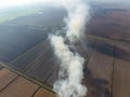 Burning straw in the fields after harvesting wheat Royalty Free Stock Photo