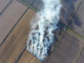 Burning straw in the fields after harvesting wheat Royalty Free Stock Photo