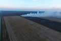 Burning straw in the fields after harvesting wheat Royalty Free Stock Photo