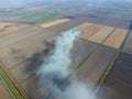 Burning straw in the fields after harvesting wheat Royalty Free Stock Photo