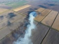 Burning straw in the fields after harvesting wheat Royalty Free Stock Photo