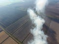 Burning straw in the fields after harvesting wheat Royalty Free Stock Photo