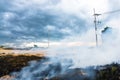 Burning straw in rice plantation. Royalty Free Stock Photo