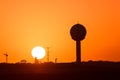 Burning sunrise next to radar antenna