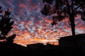 Burning sunset clouds over house. Royalty Free Stock Photo