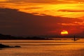 Burning sunset over the sea with a lighthouse