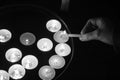 Burning tea candles on a dark background