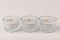 Burning tea candles isolated on white. Space for text Royalty Free Stock Photo