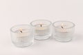 Burning tea candles isolated on white. Space for text Royalty Free Stock Photo