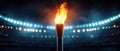Burning Torch in a Stadium with Dramatic Lighting Royalty Free Stock Photo