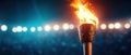 Burning Torch in a Stadium with Dramatic Lighting Royalty Free Stock Photo