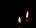 Burning two candles in right position and dark background, copyspace. Royalty Free Stock Photo