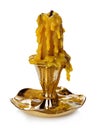Burning vintage church candle wax in old gold candlestick on white background.