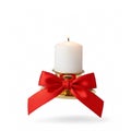A burning white candle in a gold holder with a large red bow Royalty Free Stock Photo
