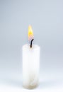Burning white candle on the gray background. Close up photo Royalty Free Stock Photo