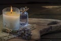 Burning white candle light on old dark wooden table background burlap sack Halloween Aromatherapy smoke rustic cutting board Royalty Free Stock Photo