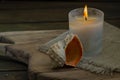 Burning white candle light on old dark wooden table background burlap sack Halloween Aromatherapy smoke rustic cutting board Royalty Free Stock Photo